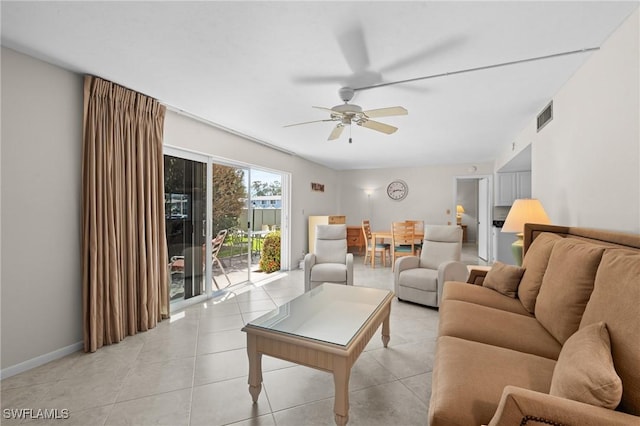 tiled living room featuring ceiling fan