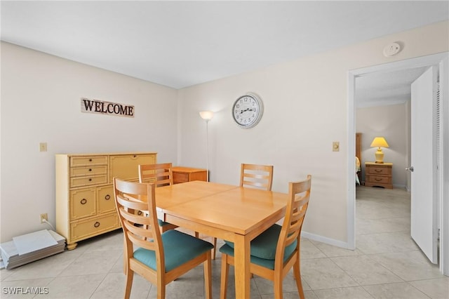 dining space featuring light tile patterned floors