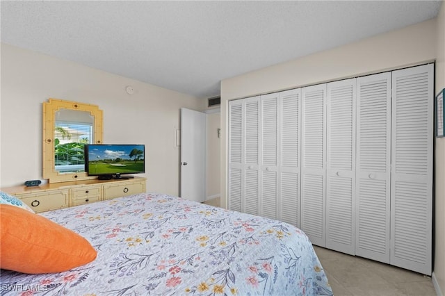 bedroom with a closet and a textured ceiling