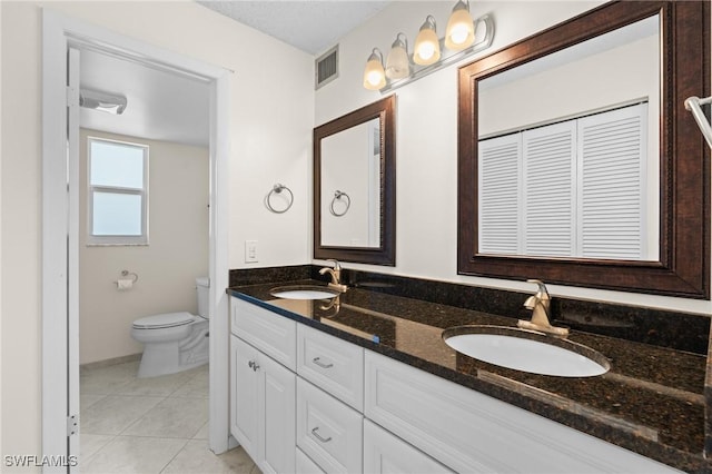 bathroom featuring tile patterned floors, toilet, and vanity