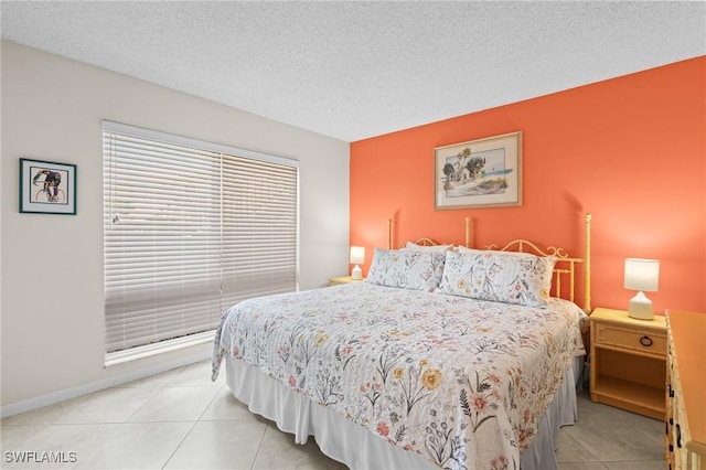 tiled bedroom featuring a textured ceiling