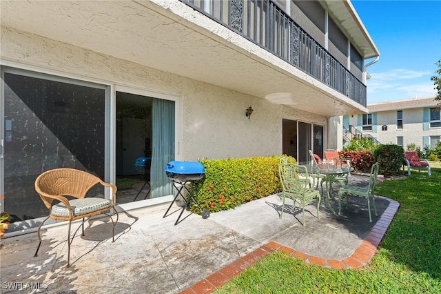 view of patio with a balcony and area for grilling