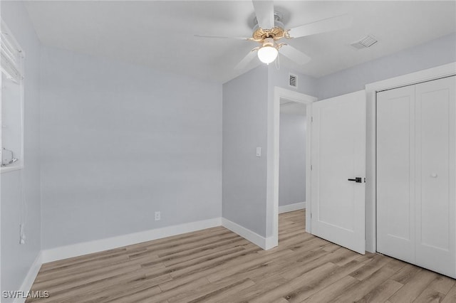 unfurnished bedroom with baseboards, visible vents, and light wood finished floors