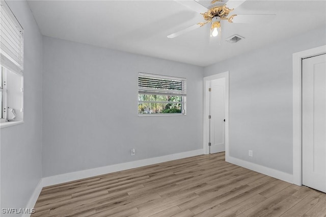 unfurnished bedroom with ceiling fan, light wood-type flooring, visible vents, and baseboards