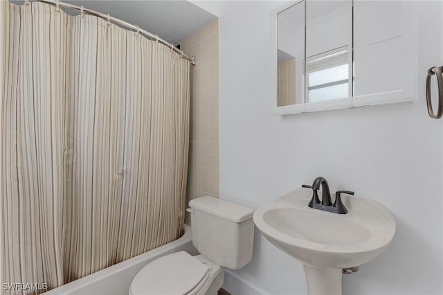 full bath featuring toilet, shower / tub combo, and a sink