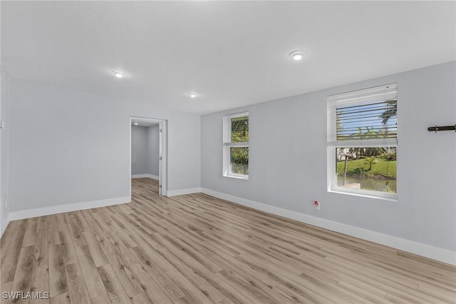 unfurnished room featuring light wood-style flooring and baseboards