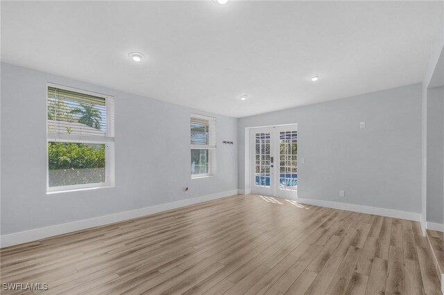 14819 Randolph Ct, Fort Myers, FL 33905 - empty room featuring french doors, light wood-type flooring, healthy amount of natural light, baseboards, and recessed lighting