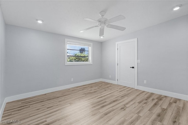 spare room with a ceiling fan, recessed lighting, light wood-style flooring, and baseboards