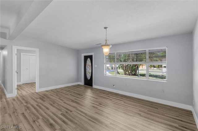 entryway with baseboards, visible vents, and light wood-style floors