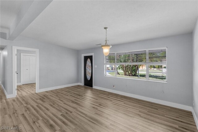14819 Randolph Ct, Fort Myers, FL 33905 - empty room with baseboards, wood finished floors, and beamed ceiling