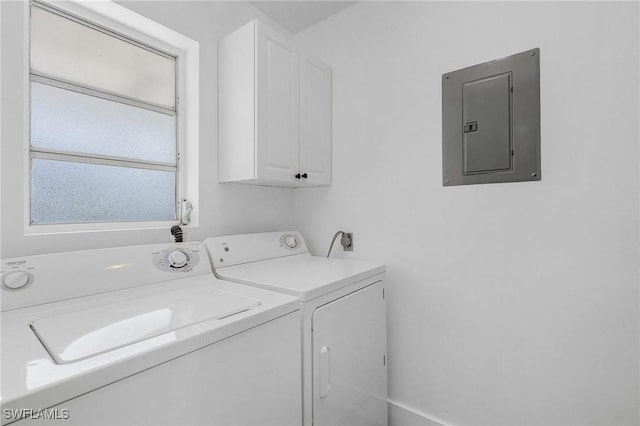 washroom featuring cabinet space, washing machine and dryer, and electric panel