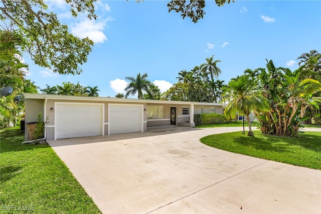 ranch-style home with an attached garage, driveway, and a front lawn