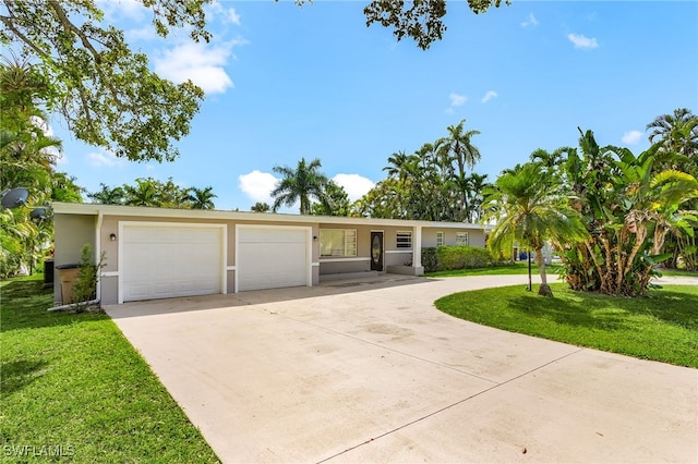 14819 Randolph Ct, Fort Myers, FL 33905 - ranch-style house featuring driveway, a front lawn, stucco siding, and an attached garage