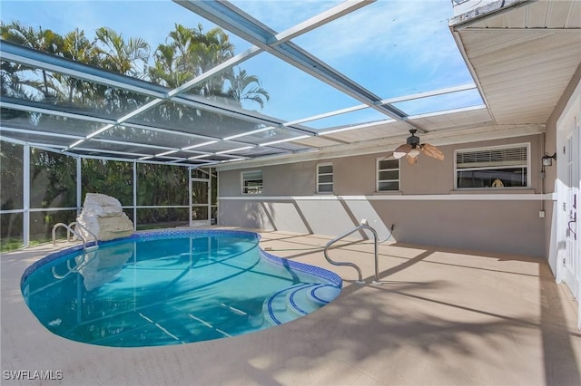 pool featuring glass enclosure and a patio