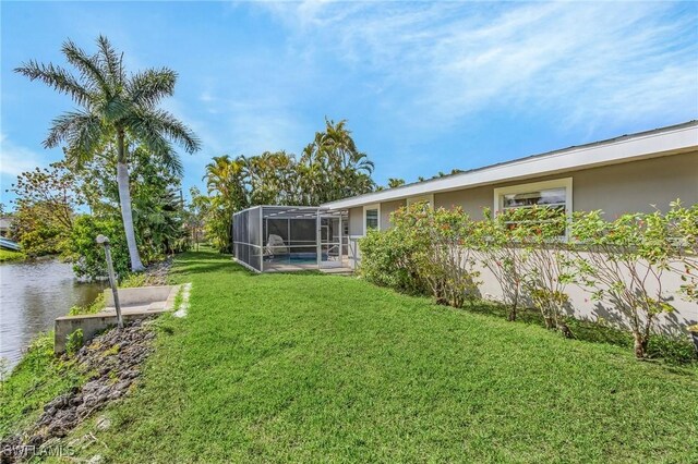 14819 Randolph Ct, Fort Myers, FL 33905 - view of grassy yard featuring a water view, a lanai, and an outdoor pool