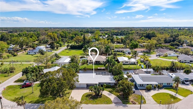 birds eye view of property featuring a wooded view and a residential view