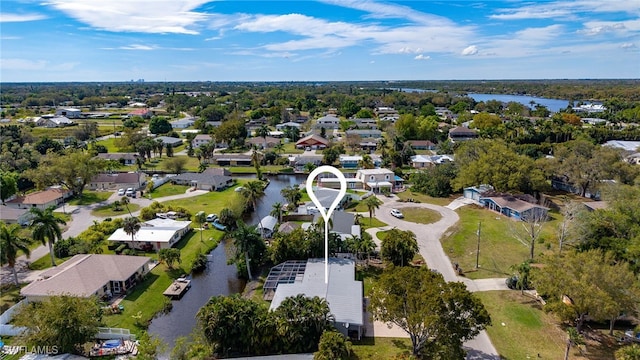 drone / aerial view featuring a residential view and a water view