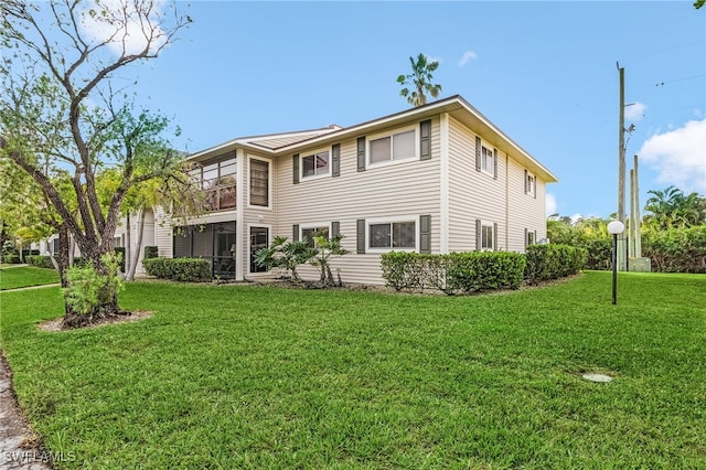 rear view of property with a lawn