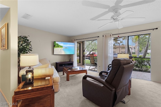 carpeted living room with ceiling fan