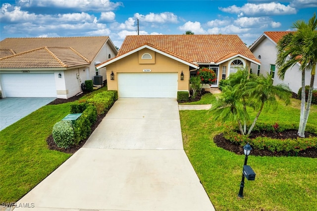 view of front of house with a garage, a front yard, and central AC unit