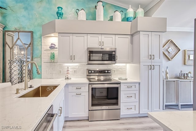 16380 Kelly Woods Dr, Fort Myers, FL 33908 - kitchen with white cabinetry, light stone countertops, appliances with stainless steel finishes, and sink