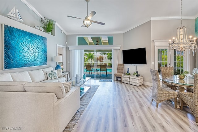 16380 Kelly Woods Dr, Fort Myers, FL 33908 - living room featuring crown molding, ceiling fan with notable chandelier, light hardwood / wood-style floors, and a healthy amount of sunlight