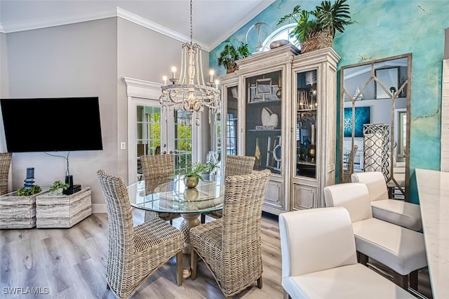 16380 Kelly Woods Dr, Fort Myers, FL 33908 - dining room featuring vaulted ceiling, a chandelier, ornamental molding, light hardwood / wood-style floors, and french doors