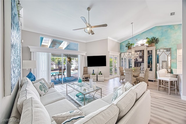 16380 Kelly Woods Dr, Fort Myers, FL 33908 - living room featuring ceiling fan with notable chandelier, ornamental molding, vaulted ceiling, and light wood-type flooring