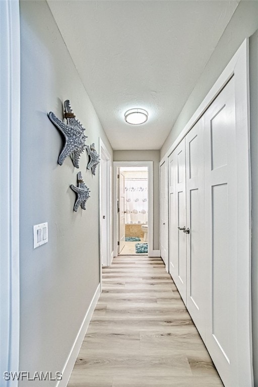 16380 Kelly Woods Dr, Fort Myers, FL 33908 - hall with light hardwood / wood-style flooring and a textured ceiling