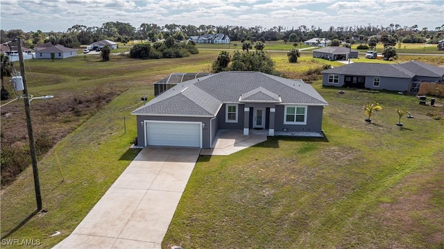 view of front of home with a lanai, a front yard, and a garage