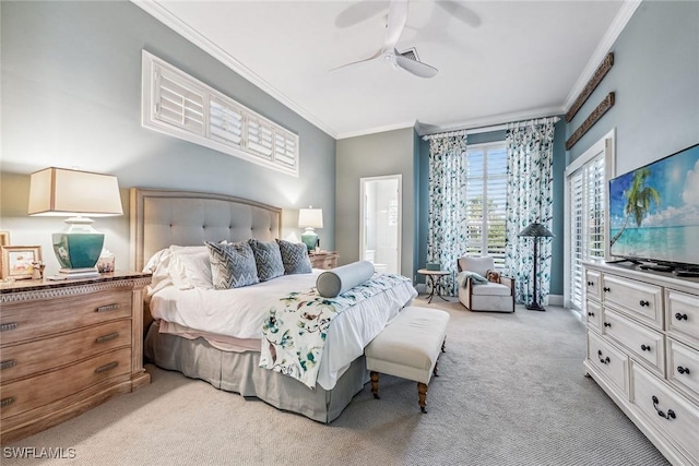 carpeted bedroom with crown molding, ensuite bathroom, and ceiling fan