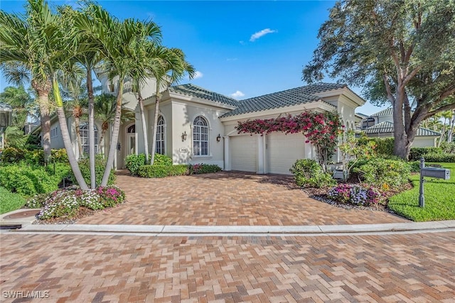26372 Augusta Creek Ct, Bonita Springs, FL 34134 - mediterranean / spanish-style home featuring a garage