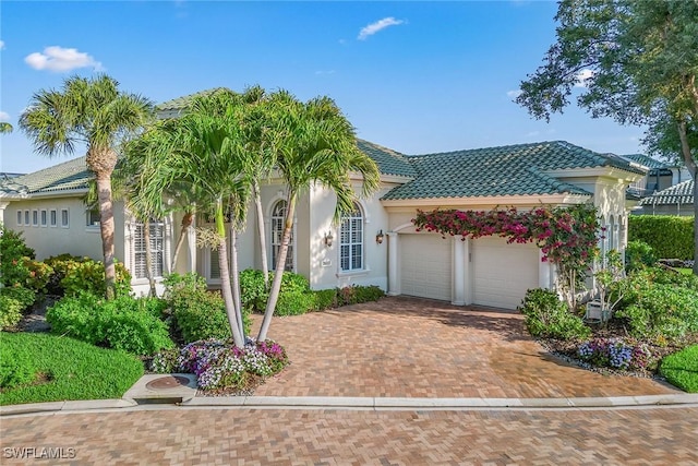 mediterranean / spanish-style home with a garage