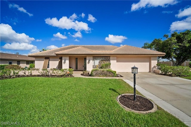 view of front of house with driveway, a front lawn, an attached garage, and stucco siding