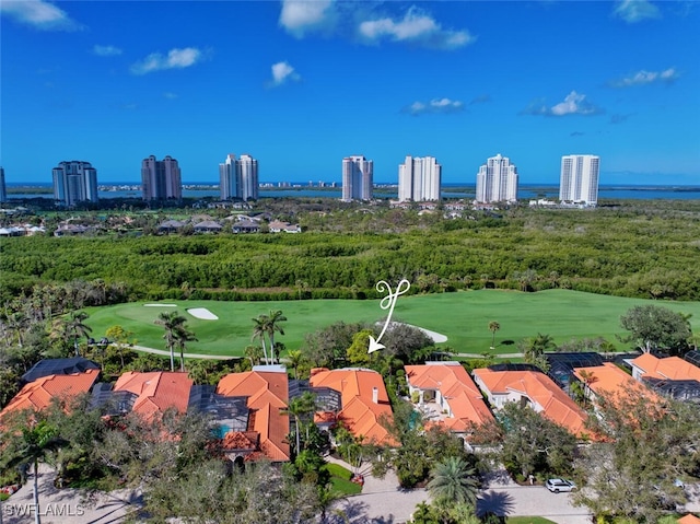 birds eye view of property with a view of city and golf course view