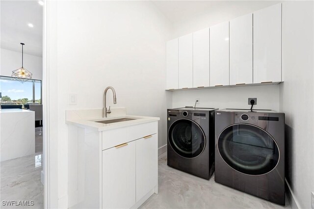 413 SW 46th Ter, Cape Coral, FL 33914 - laundry area with washer and clothes dryer, cabinet space, and a sink