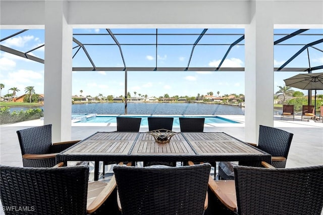 413 SW 46th Ter, Cape Coral, FL 33914 - view of patio / terrace with glass enclosure, an outdoor pool, outdoor dining area, and a water view