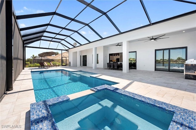 413 SW 46th Ter, Cape Coral, FL 33914 - view of pool with glass enclosure, a patio, a ceiling fan, and a pool with connected hot tub
