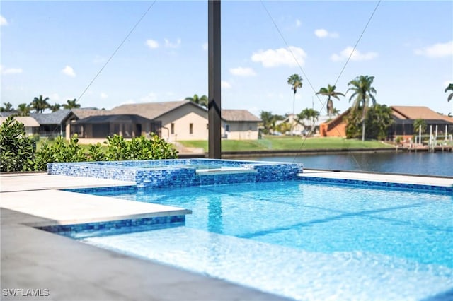 413 SW 46th Ter, Cape Coral, FL 33914 - view of swimming pool with a water view, a residential view, and a pool with connected hot tub