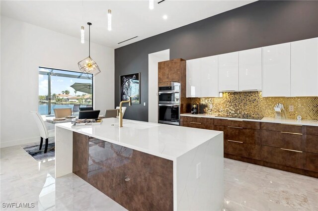 413 SW 46th Ter, Cape Coral, FL 33914 - kitchen with stainless steel double oven, white cabinets, black electric stovetop, modern cabinets, and marble finish floor