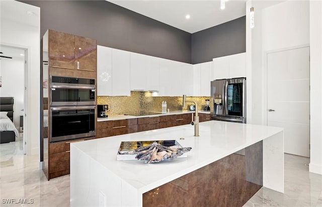 413 SW 46th Ter, Cape Coral, FL 33914 - kitchen featuring light countertops, appliances with stainless steel finishes, white cabinetry, modern cabinets, and marble finish floor