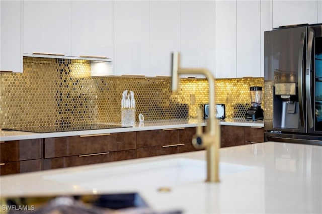 413 SW 46th Ter, Cape Coral, FL 33914 - kitchen featuring modern cabinets, white cabinetry, stainless steel fridge, light countertops, and decorative backsplash