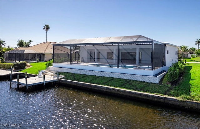 413 SW 46th Ter, Cape Coral, FL 33914 - back of house featuring an outdoor pool, glass enclosure, a water view, and a lawn