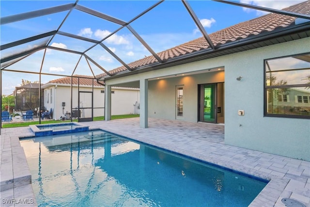 4320 Vasco St, Punta Gorda, FL 33950 - view of swimming pool with glass enclosure, a pool with connected hot tub, and a patio area