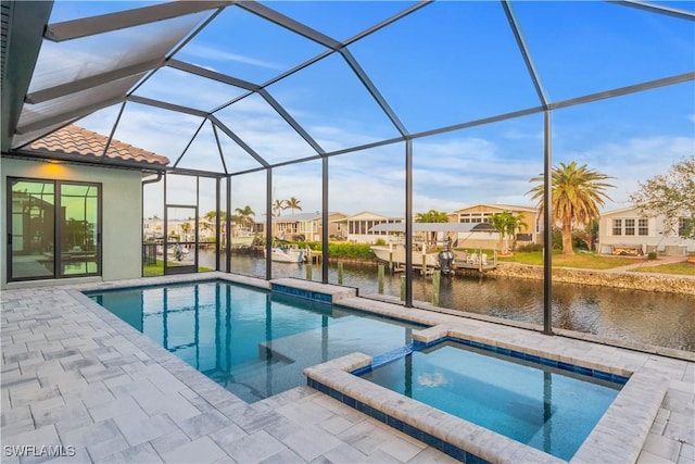 4320 Vasco St, Punta Gorda, FL 33950 - view of swimming pool featuring a patio, a pool with connected hot tub, a water view, a residential view, and a lanai