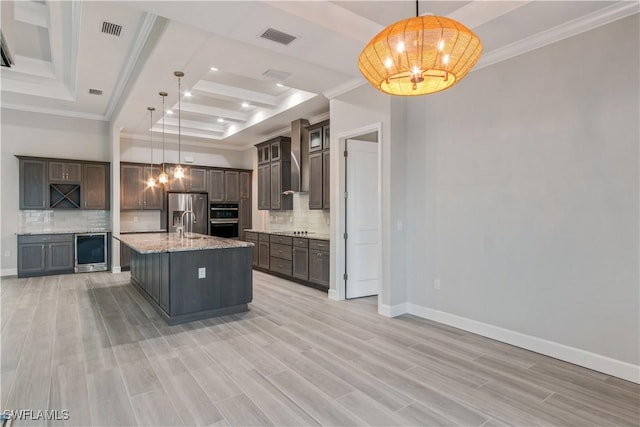 4320 Vasco St, Punta Gorda, FL 33950 - kitchen with beverage cooler, visible vents, hanging light fixtures, an island with sink, and stainless steel fridge
