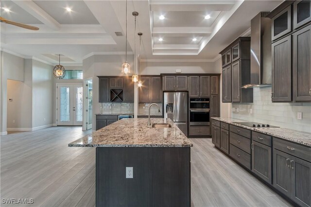 4320 Vasco St, Punta Gorda, FL 33950 - kitchen featuring decorative light fixtures, a center island with sink, appliances with stainless steel finishes, a sink, and wall chimney exhaust hood