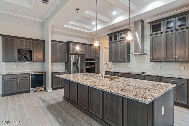 4320 Vasco St, Punta Gorda, FL 33950 - kitchen with wine cooler, a sink, wall chimney range hood, black appliances, and glass insert cabinets