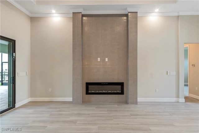 4320 Vasco St, Punta Gorda, FL 33950 - unfurnished living room with baseboards, crown molding, light wood finished floors, and a tiled fireplace