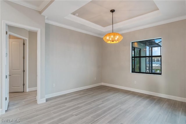4320 Vasco St, Punta Gorda, FL 33950 - empty room featuring light wood-style floors, a tray ceiling, and baseboards